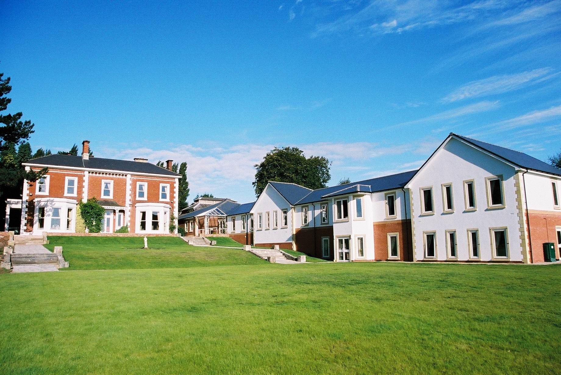 Aldridge Court Nursing Home seen across the lawn