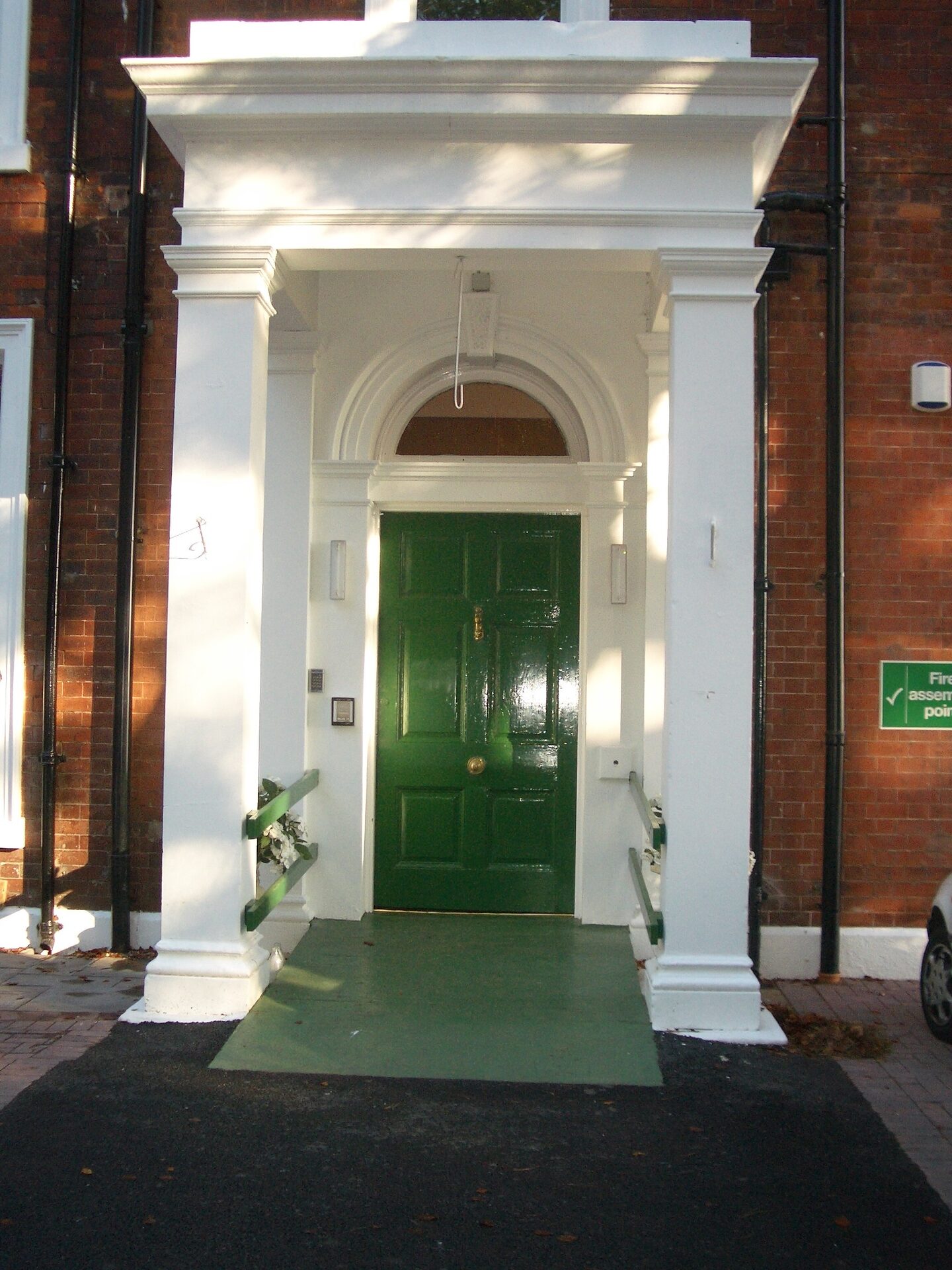 The columned portico and green front door at Aldridge Court